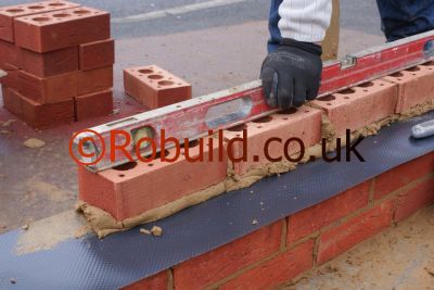 bricklayer building brick wall