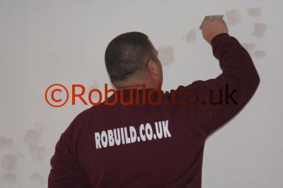 painter decorator filling cracks walls